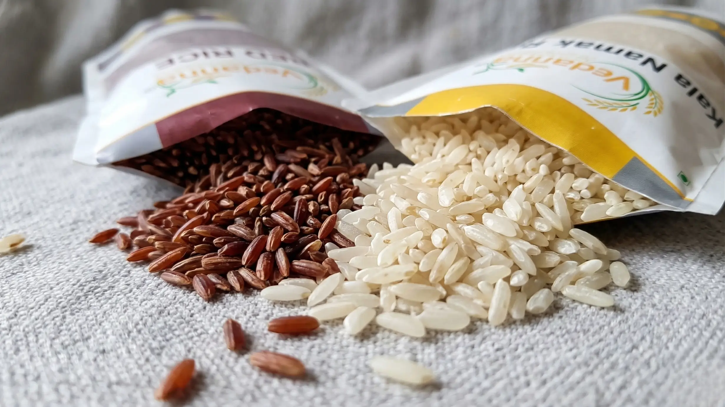 Close-up of Kalanamak rice and red rice grains showing natural low GI diabetic friendly healthy rice Vedanna